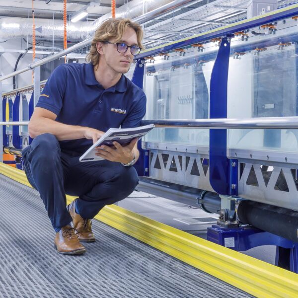 Armfield employee inspects flume